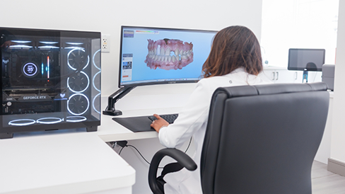 Dentist looking at digital scans of a patient's teeth