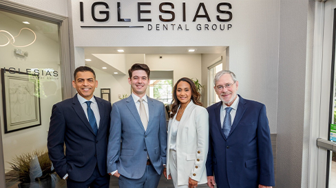 Four smiling dental professionals at Iglesias Dental Group