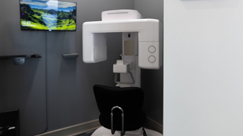 Cone beam CT scanner standing against a wall