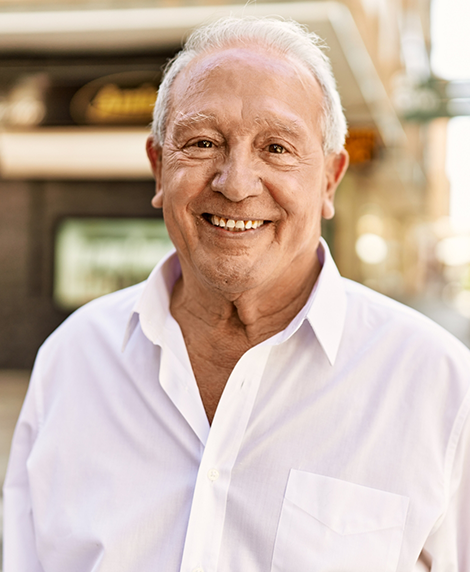 Senior man smiling with All on X implant dentures in Coral Springs