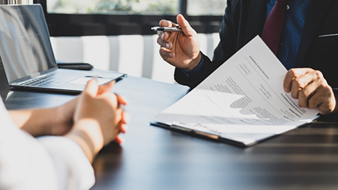 Two people at a table discussing dental insurance