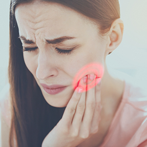 Woman holding the side of her face in pain
