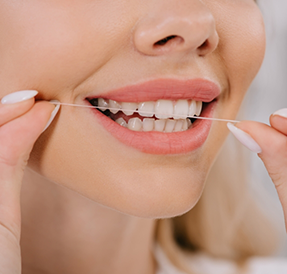Woman flossing her teeth