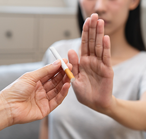 Woman refusing an offer of a cigarette