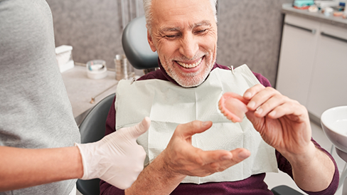 Senior man receiving a denture