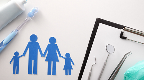 Clipboard next to dental instruments