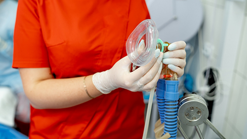 Dentist holding a nose mask for nitrous oxide
