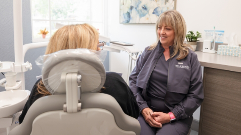 Dental team member talking to a patient
