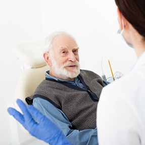Senior man listening to his dentist