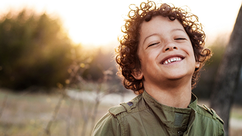 Smiling child with curly brown hair