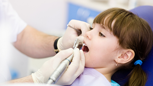 Young girl receiving a dental cleaning