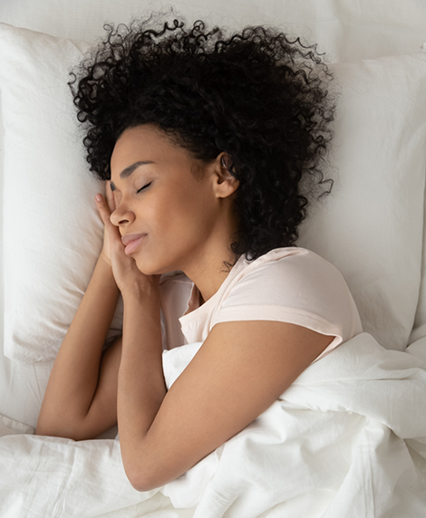 Woman sleeping on her side after sleep apnea treatment in Coral Springs