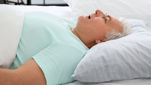 Man sleeping on his back with his mouth open