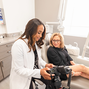 Dentist showing a camera to a patient
