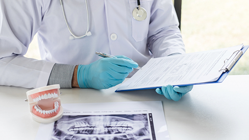 Dentist looking at a patient's charts