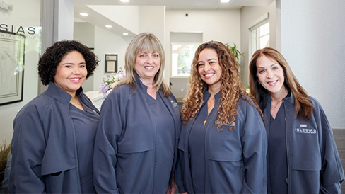 Four smiling dental hygienists at Iglesias Dental Group