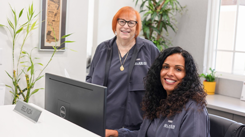 Two smiling dental team members at Iglesias Dental Group