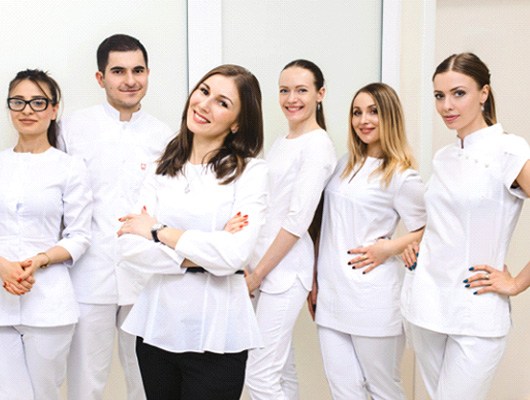 A team of dental office staff smiling