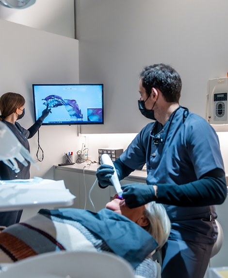 Dentist examining a patient's mouth before oral surgery in Coral Springs
