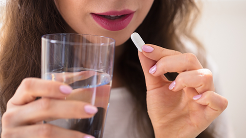 Woman taking a pill