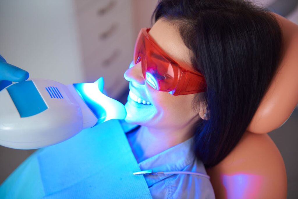 A woman getting a professional teeth whitening treatment.